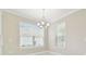 Dining room with neutral walls, white trim and two windows with blinds at 4709 Isonzo Way, Wesley Chapel, FL 33543