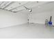 Spacious three car garage with a clean, epoxy floor at 4709 Isonzo Way, Wesley Chapel, FL 33543