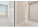 Hallway featuring grey carpet, bright white trim, and views to multiple rooms at 4709 Isonzo Way, Wesley Chapel, FL 33543