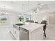 Kitchen island featuring stainless steel appliances, quartz countertops, and seating at 4709 Isonzo Way, Wesley Chapel, FL 33543