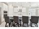 Open concept kitchen featuring a large island with seating, stainless steel appliances, and pendant lighting at 4709 Isonzo Way, Wesley Chapel, FL 33543