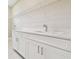 Laundry room with white cabinets, quartz countertops and a stainless steel sink at 4709 Isonzo Way, Wesley Chapel, FL 33543