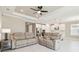 Open living area featuring comfortable sofas, modern flooring, and seamless flow into the kitchen at 4709 Isonzo Way, Wesley Chapel, FL 33543