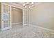 Office with neutral walls, white trim and glass panel french doors at 4709 Isonzo Way, Wesley Chapel, FL 33543