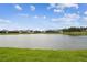 Scenic pond surrounded by lush greenery and well-maintained lawns at 4709 Isonzo Way, Wesley Chapel, FL 33543