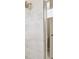 Close-up of a tiled shower featuring a rain shower head and glass door at 4709 Isonzo Way, Wesley Chapel, FL 33543