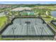 Aerial shot of well-maintained tennis courts with clubhouse, pool and lush landscaping in a desirable community at 4709 Isonzo Way, Wesley Chapel, FL 33543