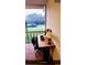 Tiled balcony features a desk area with a view of green landscaped grounds at 4801 Airport Rd # 210, Zephyrhills, FL 33542