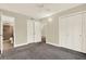 This cozy bedroom has neutral paint, grey carpet, updated ceiling fan, and a spacious closet for storage at 4801 Airport Rd # 210, Zephyrhills, FL 33542