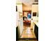 View from kitchen with tile floor looking into an adjacent living room at 4801 Airport Rd # 210, Zephyrhills, FL 33542