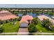 Waterfront home with a red tile roof, beautiful landscaping, and a spacious lawn at 4821 Grand Banks Dr, Wimauma, FL 33598