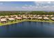 Scenic aerial view of homes along the lake, highlighting a tranquil waterfront living experience at 4821 Grand Banks Dr, Wimauma, FL 33598