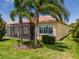 Lovely backyard featuring a screened-in lanai, well-manicured lawn, and tropical palm trees at 4821 Grand Banks Dr, Wimauma, FL 33598