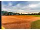 Well-maintained baseball field with an expansive outfield and clear skies at 4821 Grand Banks Dr, Wimauma, FL 33598