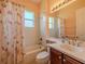Bright bathroom featuring a shower and tub combination and a flamingo-themed shower curtain at 4821 Grand Banks Dr, Wimauma, FL 33598