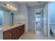 Bathroom view with vanity, commode, and doorway to bedroom at 4821 Grand Banks Dr, Wimauma, FL 33598