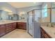 A relaxing bathroom with a walk-in shower and double vanities at 4821 Grand Banks Dr, Wimauma, FL 33598