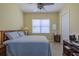 Comfortable bedroom with a ceiling fan, neutral walls, tiled floor, and a large window for natural light at 4821 Grand Banks Dr, Wimauma, FL 33598