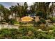 Valencia Lakes entrance with lush landscaping and tranquil water feature at 4821 Grand Banks Dr, Wimauma, FL 33598
