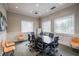 Well-lit conference room featuring a large table, comfortable seating, and neutral decor at 4821 Grand Banks Dr, Wimauma, FL 33598