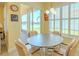 Cozy dining area with a view of the lake and a screened-in lanai, perfect for enjoying meals with a view at 4821 Grand Banks Dr, Wimauma, FL 33598