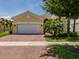 Charming single Gathering home featuring a 2-car garage, brick driveway, and well-maintained landscaping at 4821 Grand Banks Dr, Wimauma, FL 33598