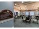 Well-lit card and game room featuring tables, chairs, and comfortable lighting for community enjoyment at 4821 Grand Banks Dr, Wimauma, FL 33598