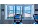 Modern treadmill with a view of the lake in the community gym at 4821 Grand Banks Dr, Wimauma, FL 33598