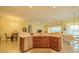 Open kitchen with stainless steel appliances, breakfast nook, tile floors, and an airy, open concept design at 4821 Grand Banks Dr, Wimauma, FL 33598