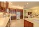 Open-concept kitchen with stainless steel appliances, stone countertops, and ample cabinet space at 4821 Grand Banks Dr, Wimauma, FL 33598