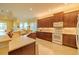 This kitchen showcases a modern aesthetic with stone countertops and backsplash, and stainless steel appliances at 4821 Grand Banks Dr, Wimauma, FL 33598
