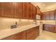 The kitchen features stone countertops, stainless appliances, and under cabinet lighting at 4821 Grand Banks Dr, Wimauma, FL 33598