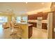 Bright kitchen features a breakfast bar with seating, stainless steel appliances, and recessed lighting at 4821 Grand Banks Dr, Wimauma, FL 33598