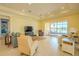 Bright living room features tile floors, comfortable seating, and a screened patio with lake views at 4821 Grand Banks Dr, Wimauma, FL 33598