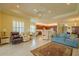 Open-concept living room with tile flooring, multiple seating areas, and an adjacent open kitchen at 4821 Grand Banks Dr, Wimauma, FL 33598