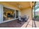 Inviting outdoor patio with brick flooring, an outdoor table and view to an adjacent living area at 4821 Grand Banks Dr, Wimauma, FL 33598