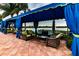 Outdoor patio with comfortable seating arrangements under shaded canopies overlooking a scenic waterfront view at 4821 Grand Banks Dr, Wimauma, FL 33598