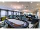 Entertaining poker room featuring poker tables, chairs, and elegant lighting for community members to gather at 4821 Grand Banks Dr, Wimauma, FL 33598