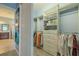 Organized walk-in closet with custom shelving and hanging rods at 4821 Grand Banks Dr, Wimauma, FL 33598