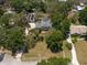 Expansive property featuring a traditional home, pool, and additional structure, all nestled among mature trees at 5305 Lenoir Ct, Plant City, FL 33566