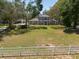 Aerial view of a home, showcasing its landscaping, driveway, and serene, tree-lined surroundings at 5305 Lenoir Ct, Plant City, FL 33566