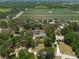 Aerial view capturing a home with pool, outbuilding, and surrounding greenery, showcasing the neighborhood's serene setting at 5305 Lenoir Ct, Plant City, FL 33566