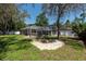 Expansive backyard featuring a screened pool enclosure, perfect for outdoor entertaining and relaxation at 5305 Lenoir Ct, Plant City, FL 33566