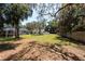 Open backyard view, showcasing the screened pool enclosure and surrounding greenery at 5305 Lenoir Ct, Plant City, FL 33566