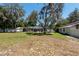 Vast backyard showcasing a screened pool enclosure, ideal for enjoying outdoor living at 5305 Lenoir Ct, Plant City, FL 33566