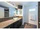 Bathroom featuring a glass vessel sink, granite countertop, and glass shower at 5305 Lenoir Ct, Plant City, FL 33566