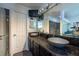 Bathroom featuring dual vessel sinks on a granite countertop, mirrors, and white cabinets at 5305 Lenoir Ct, Plant City, FL 33566