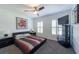 Bedroom featuring a ceiling fan, carpeted floors, mounted TV, and large painting at 5305 Lenoir Ct, Plant City, FL 33566