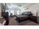 Tranquil main bedroom with tray ceiling, ceiling fan, plush carpet, and decorative windows at 5305 Lenoir Ct, Plant City, FL 33566