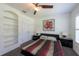 Bedroom featuring a ceiling fan, carpeted floors, built-in shelves, and closet at 5305 Lenoir Ct, Plant City, FL 33566